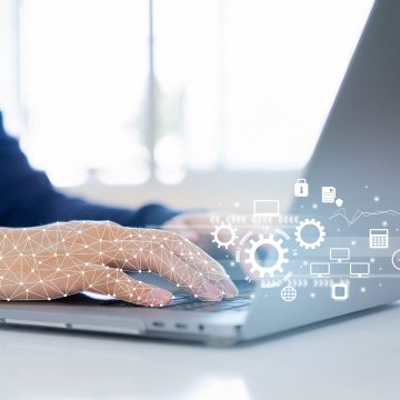 Laptop open with hands over keyboard